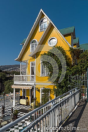 Beautiful traditional yellow wooden building in Valparaiso, Chile Editorial Stock Photo