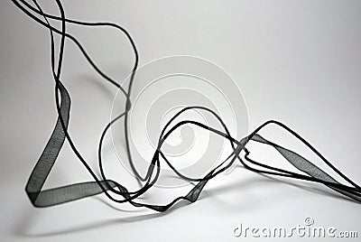 Beautiful translucent ribbons and ribbons with threads, randomly located all over the white surface. Stock Photo