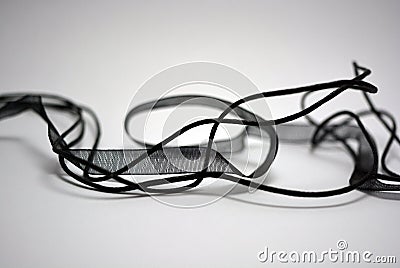 Beautiful translucent ribbons and ribbons with threads, randomly located all over the white surface. Stock Photo