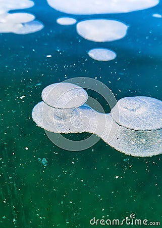 Beautiful transparent blue ice and frozen methane bubbles on Baikal Lake Stock Photo