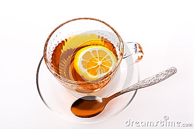 Beautiful transparent Cup with saucer with tea and lemon. Stock Photo