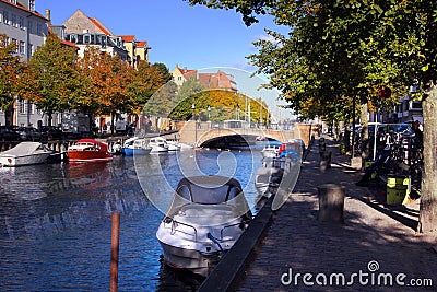 A beautiful tree-lined canal with boats and houses Stock Photo