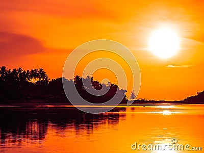 Beautiful tropical beach sea and ocean with coconut palm tree at sunrise time Stock Photo