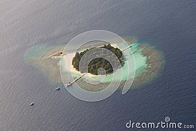 Beautiful tropical island at ocean aerial view from seaplane at Maldives Stock Photo