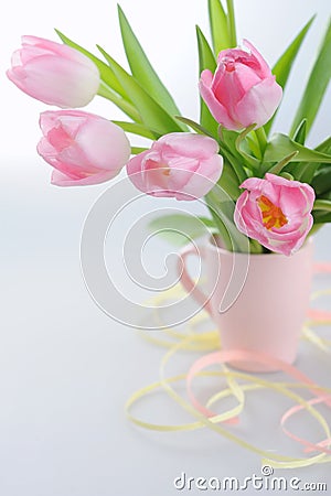 Beautiful tulips in a vase with decorative paper Stock Photo