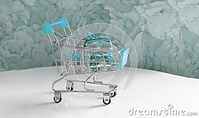 Beautiful turquoise gifts with ribbon in a basket on a white table and with a turquoise background Stock Photo