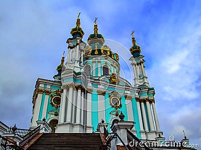 Beautiful turquoise St. Andrew`s Church in Kiev, isolated on a background of blue sky. Bottom view of the magnificent baroque Stock Photo