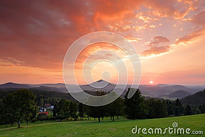 Beautiful twilight sunset landscape. Evening in hills with villages. Sun with ping and orange sky. Evening sun during sunset in Cz Stock Photo