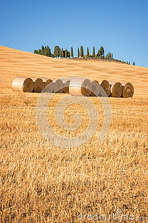 Beautiful typical landscape of Val d`Orcia in Tuscany with hay bales in a field in summer, Val d`Orcia, Tuscany Italy Stock Photo