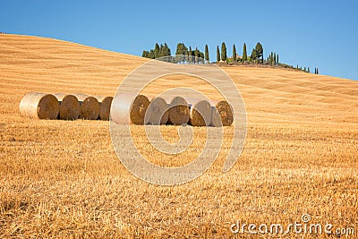 Beautiful typical landscape of Val d`Orcia in Tuscany with hay bales in a field in summer, Val d`Orcia, Tuscany Italy Stock Photo