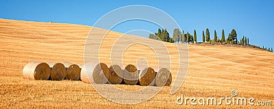 Beautiful typical panorama landscape of Val d`Orcia in Tuscany with hay bales in a field in summer, Val d`Orcia, Tuscany Italy Stock Photo