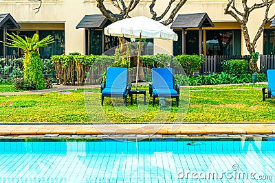 Beautiful umbrella and chair around swimming pool in hotel and resort Stock Photo