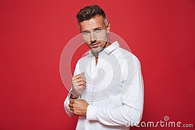 Beautiful unshaved man 30s in white shirt looking on camera, iso Stock Photo