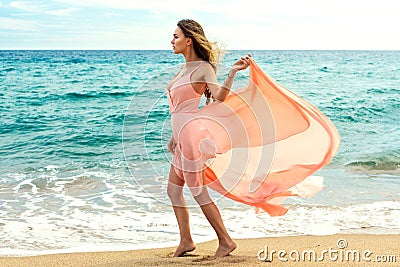 Beautiful unusual woman walking on the beach Stock Photo