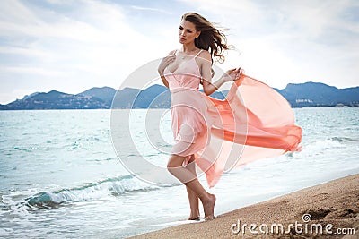 Beautiful unusual woman walking on the beach Stock Photo