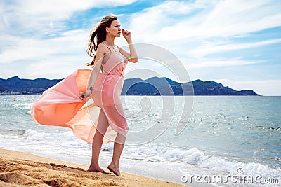 Beautiful unusual woman walking on the beach Stock Photo