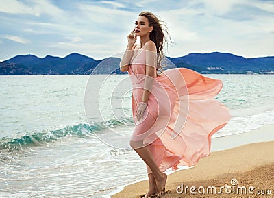 Beautiful unusual woman walking on the beach Stock Photo