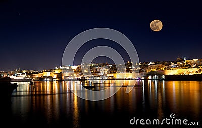 Beautiful Valletta at night with full moon in blue dark sky background with the stars Stock Photo