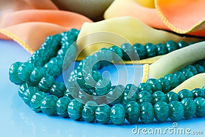 Beautiful valuable Emerald stone beads in on aquamarine backgrou Stock Photo