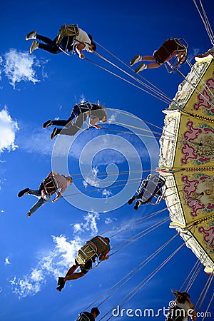 Beautiful vertical view of people enjoying carousel in a park Editorial Stock Photo