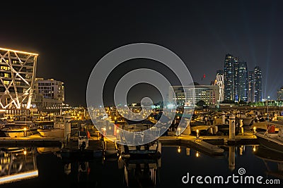 Beautiful view of Abu Dhabi city Etihad towers, famous landscape and Marina boats at night Editorial Stock Photo