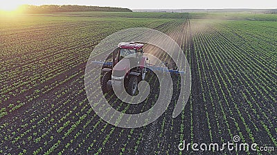 Beautiful view of agricultural tractor in the field on the sunset. Stock Photo