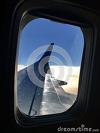 Beautiful view from airplane window, large wing of aircraft shows casement Stock Photo