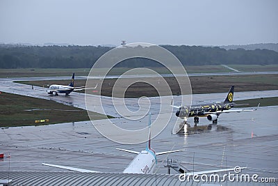 Beautiful view of airplanes on a runway in Cologne, Germany on a rainy day Editorial Stock Photo
