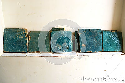 A beautiful view of the ancient blue glazed tiles on the wall ledge of an old house. Yazd, Iran Stock Photo