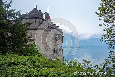 Beautiful view of the back of Chateau de Chillon Castle, The famous medieval fortress on Lake Geneva, with fresh green trees on ch Editorial Stock Photo