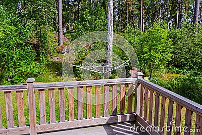 Beautiful view of backyard of private house with old wooden patio and collapsible outdoor clothes dryer view. Stock Photo