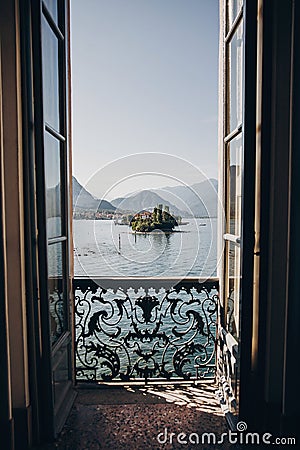 Beautiful view from balcony window at Lago Maggiore and Borromean Islands in sunny light, exploring Italy. Old architecture Stock Photo