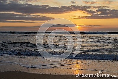 Beautiful view of Black Sea with first rays of rising sun. Magical beauty of dawn. Colorful sky with clouds and gold Stock Photo