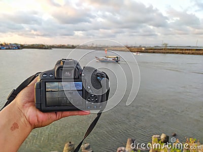 The beautiful view of Cilacap Indonesia from a DSLR camera with a seascape, fishing boats under the sky Stock Photo