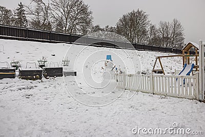 Beautiful view of exterior of small garden with funny snowman in winter day. Stock Photo