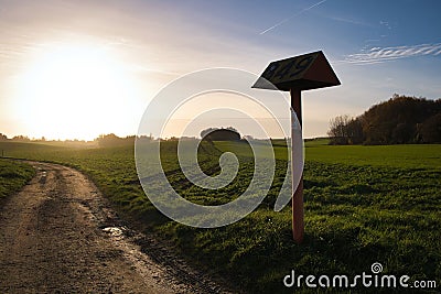 Beautiful view of a field and a sing at a beautiful sunset in Plancenoit, Belgi Stock Photo
