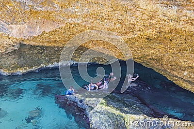 Beautiful view of group of young people swimming in gorge of Atlantic Ocean in natural pool. Editorial Stock Photo