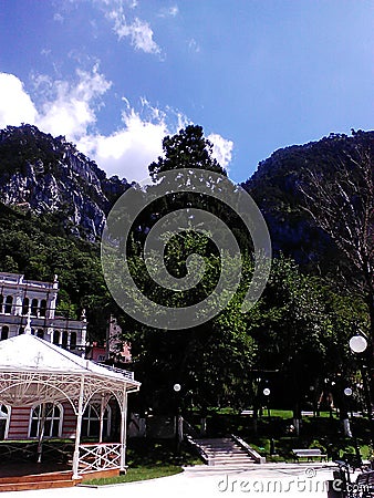 Beautiful view in Herculane spa resort of Romania, Hotel building against the mountain peaks Stock Photo