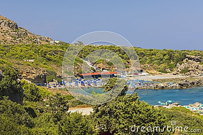 Beautiful view of hotels beach area equipped with sun beds and umbrellas on island`s coastline. Stock Photo