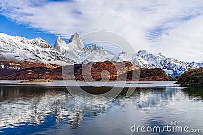 Beautiful view of lake Capri with Fitz roy mountains with white snow peak and colorful red leaves tree in sunny blue sky day in Stock Photo