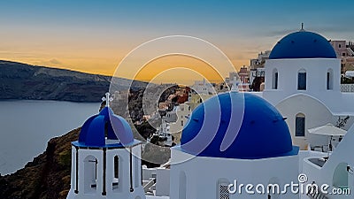 Beautiful view of look out with sunset sky scene background and blue dome church at Oia village, Santorini,Greec Stock Photo
