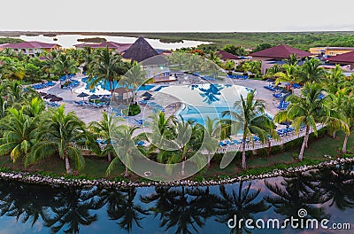 Beautiful view of Memories Caribe resort grounds, buildings and tropical garden on early morning sunrise time Editorial Stock Photo