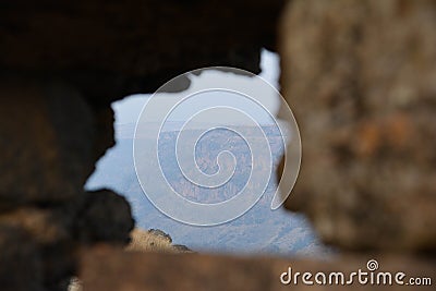 A beautiful view opens through the window of an ancient castle Stock Photo