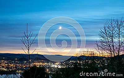 view over Inverness city from above the Kessock Bridge on a moonlit winter's night in Scotland Stock Photo