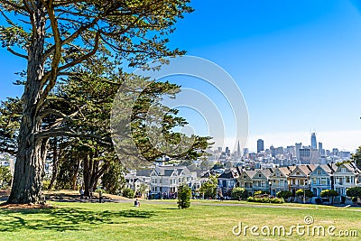 Beautiful view of Painted Ladies, colorful Victorian houses located near scenic Alamo Square in a row, on a summer day with blue Editorial Stock Photo