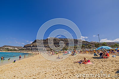 Beautiful view of people on Amadores Beach of Grand Canaria on hot summer sunny day. Gran Canary. Editorial Stock Photo