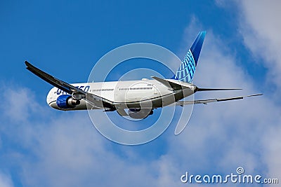 Beautiful view of a plane United Airlines Boeing 767-424(ER), sorrowing through the bright blue sky Editorial Stock Photo