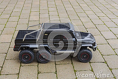 Beautiful view of radio-controlled model of Mercedes Benz racing car against backdrop of paving slabs. Editorial Stock Photo