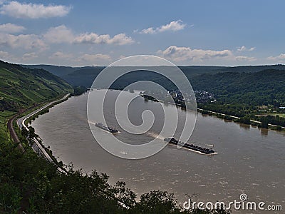 Beautiful view of Rhine river, an important inland shipping waterway, with two vessels passing by and vineyards. Editorial Stock Photo