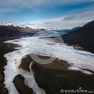 Beautiful view of river surrounded by snow-peaked mountains in New Zealand Stock Photo